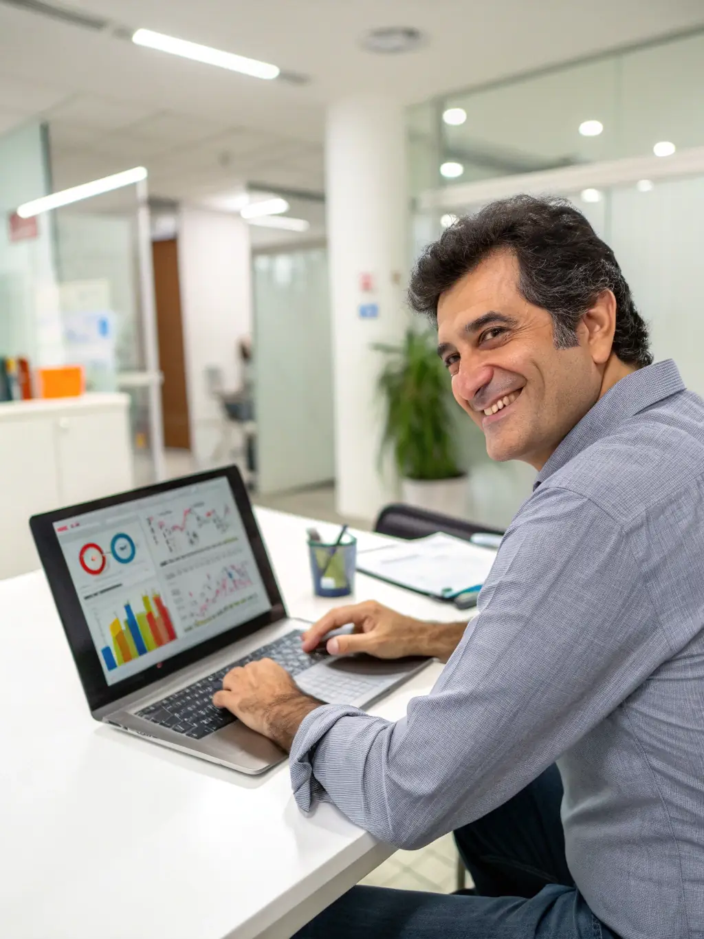 A professional businessman analyzing financial data on a modern computer screen, showcasing Our Cloud Live's analytics platform.